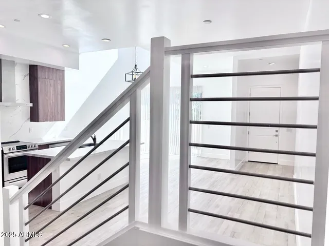 a view of staircase with white walls and a window