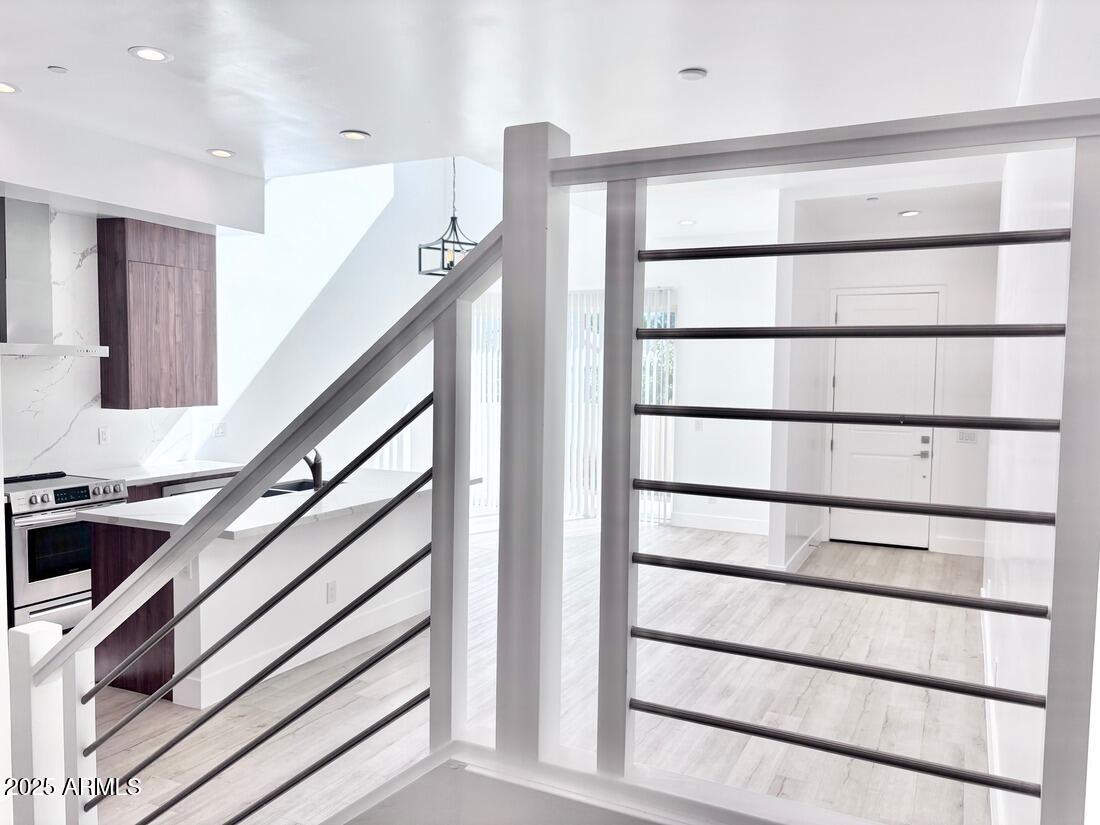 4050 North 12th Street, Unit 6 Phoenix, AZ 85014 - Photo 19 of 50 a view of staircase with white walls and a window