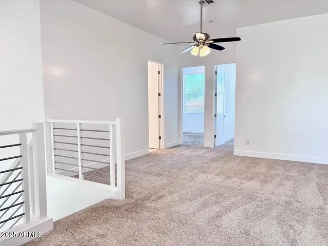 a view of a room with a ceiling fan