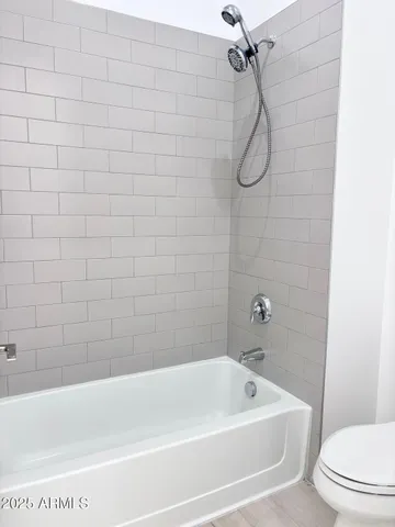 a bathroom with a bath tub with a shower