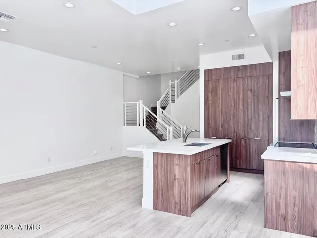 a kitchen with a stove and a wooden floor