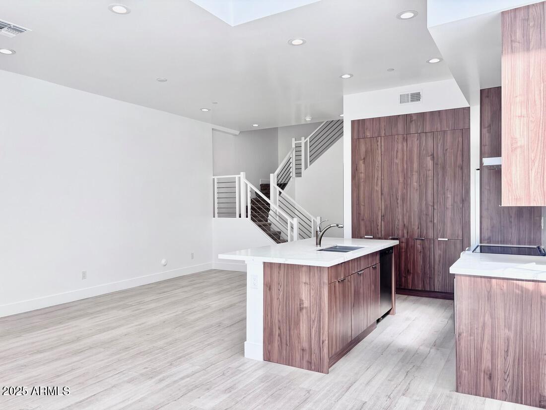 4050 North 12th Street, Unit 6 Phoenix, AZ 85014 - Photo 7 of 50 a kitchen with a stove and a wooden floor