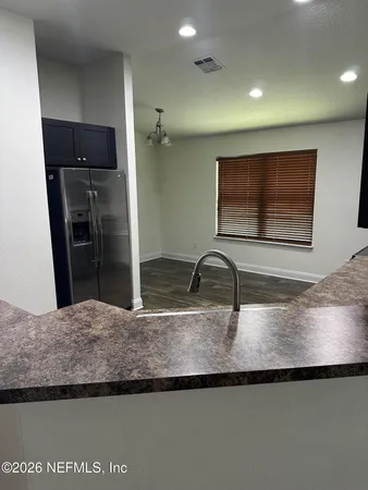 a kitchen with kitchen island a sink stainless steel appliances and a counter top