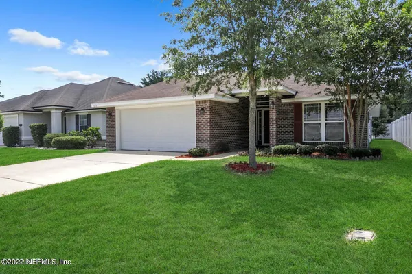 a front view of house with yard and green space