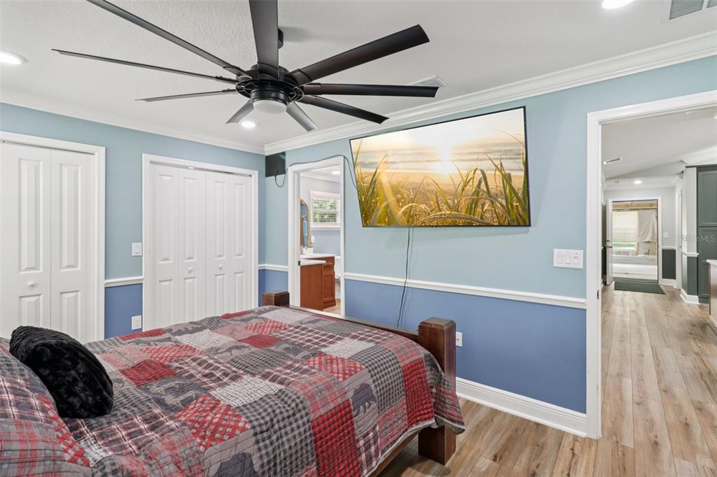 40535 Louise Road Umatilla, FL 32784 - Photo 13 of 38 a bedroom with a bed and a chandelier