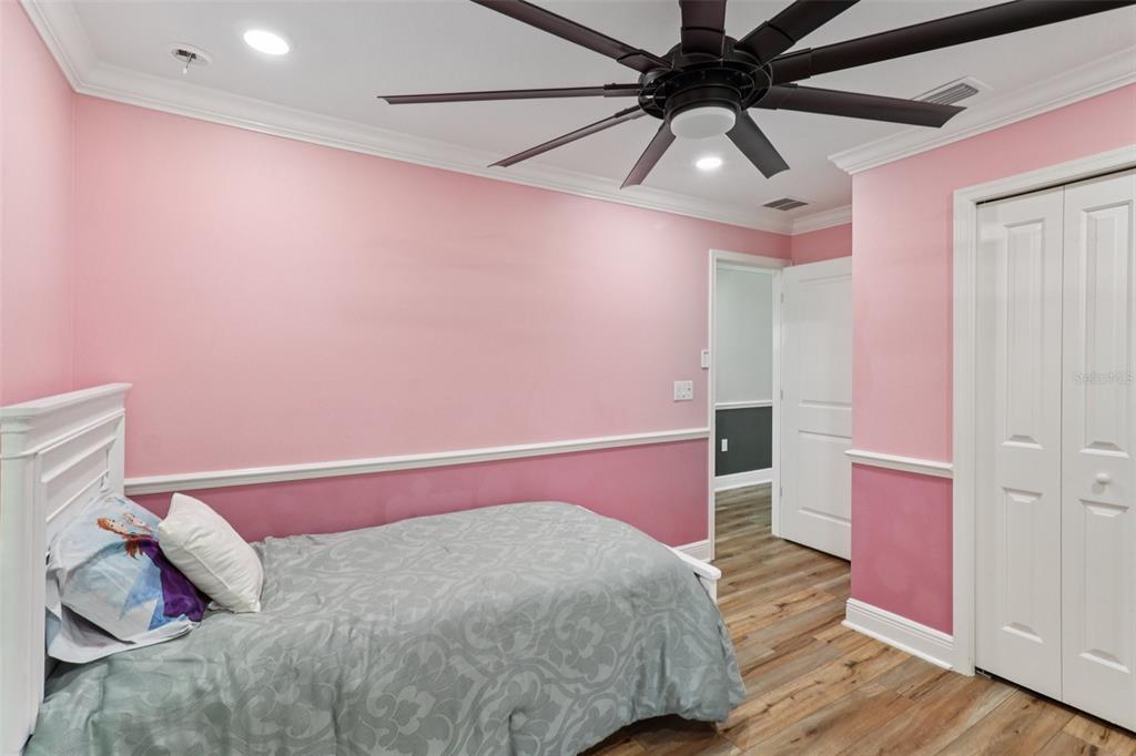 40535 Louise Road Umatilla, FL 32784 - Photo 17 of 38 a bedroom with a bed and a ceiling fan