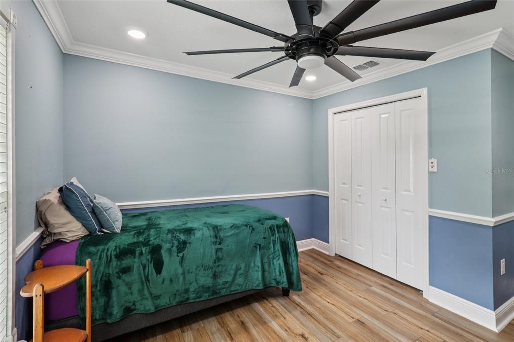 40535 Louise Road Umatilla, FL 32784 - Photo 19 of 38 a bedroom with bed and wooden floor