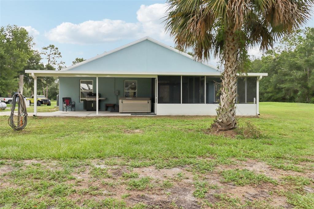 40535 Louise Road Umatilla, FL 32784 - Photo 23 of 38 a view of a house with a backyard and a tree