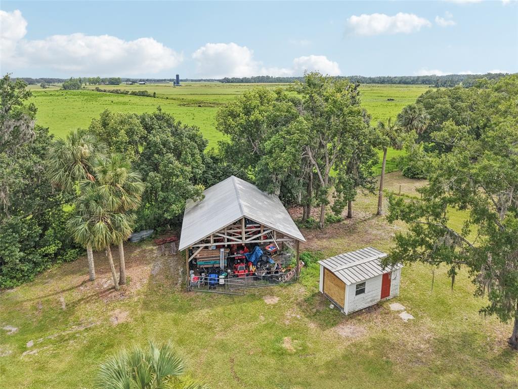 40535 Louise Road Umatilla, FL 32784 - Photo 27 of 38 a roof deck with table and chairs under an umbrella