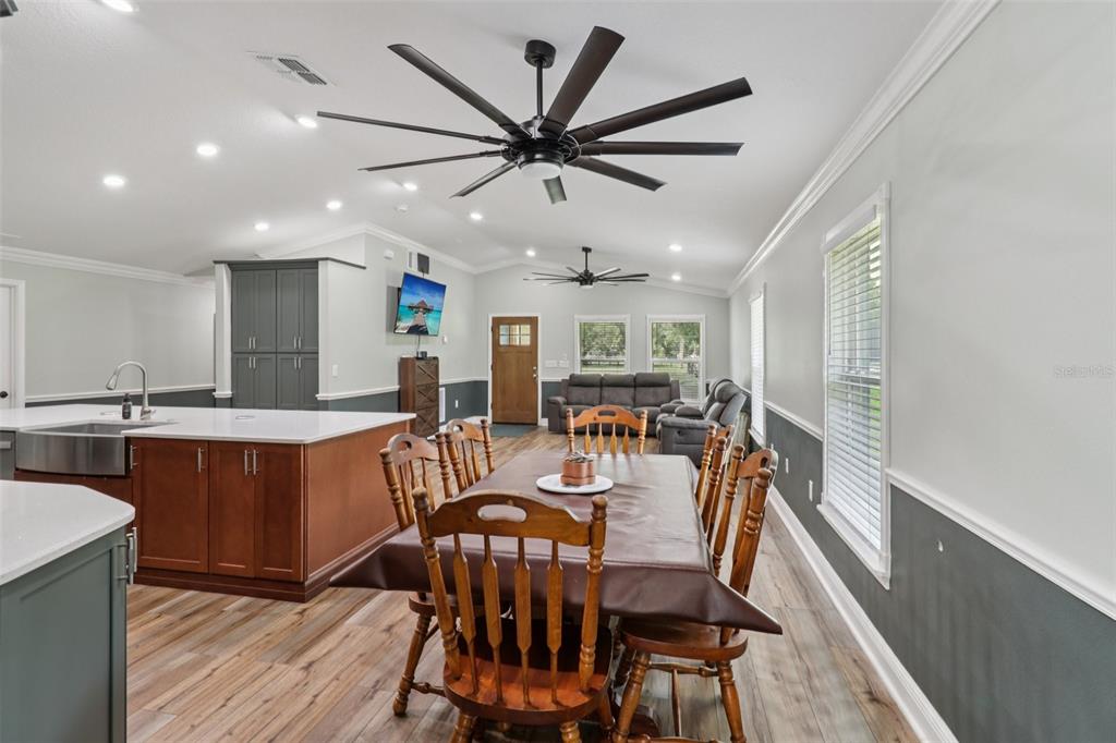 40535 Louise Road Umatilla, FL 32784 - Photo 9 of 38 a view of a dining room with furniture window and wooden floor