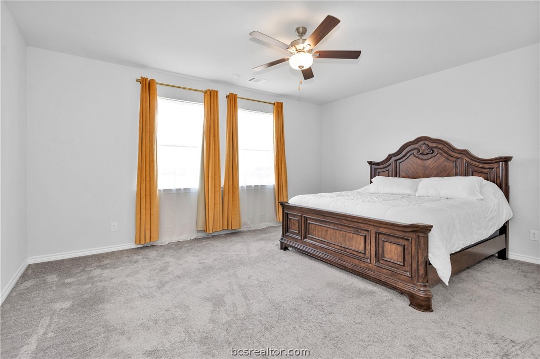 36244 Cochran Road Waller, TX 77484 - Photo 19 of 41 a spacious bedroom with a bed and a window