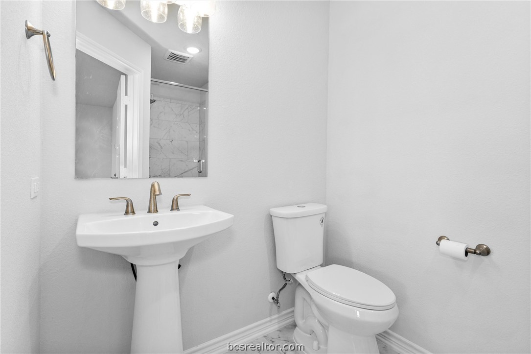 36244 Cochran Road Waller, TX 77484 - Photo 30 of 41 a bathroom with a sink toilet and a mirror