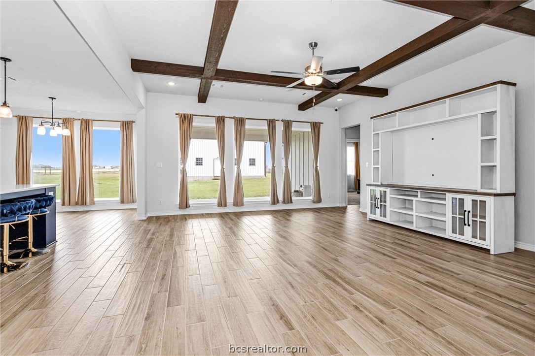 36244 Cochran Road Waller, TX 77484 - Photo 9 of 41 a view of an empty room with wooden floor and a window