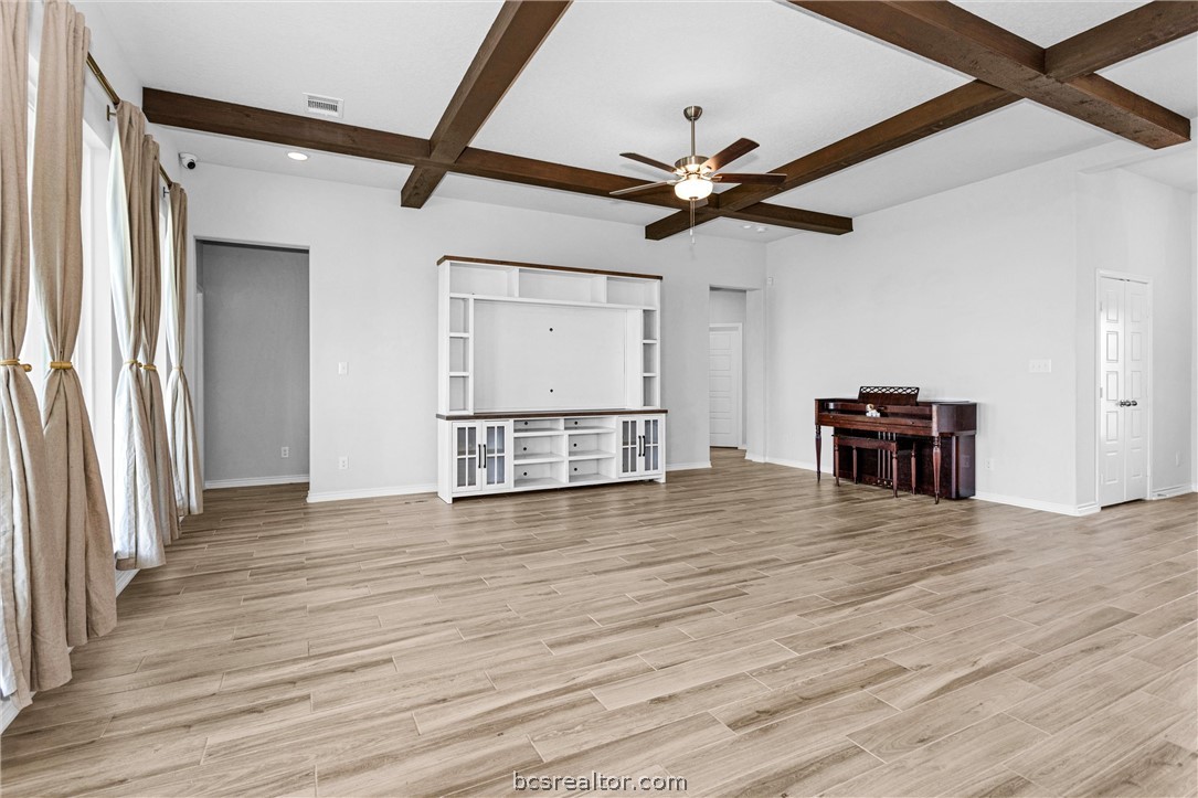 36244 Cochran Road Waller, TX 77484 - Photo 10 of 41 a view of a livingroom with wooden floor and a ceiling fan