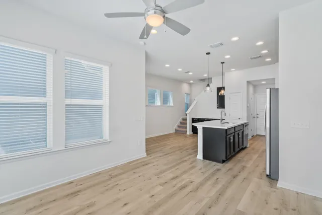 a large kitchen with kitchen island a sink stainless steel appliances and a window
