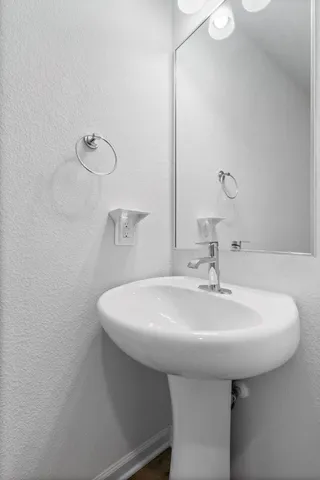 a bathroom with a sink a mirror and vanity