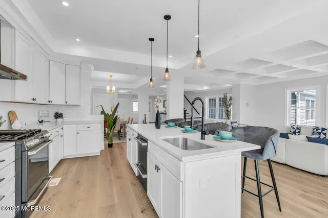 a view of empty room with wooden floor and window