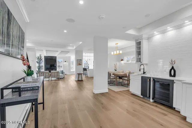 a view of a dining room with furniture a chandelier and wooden floor