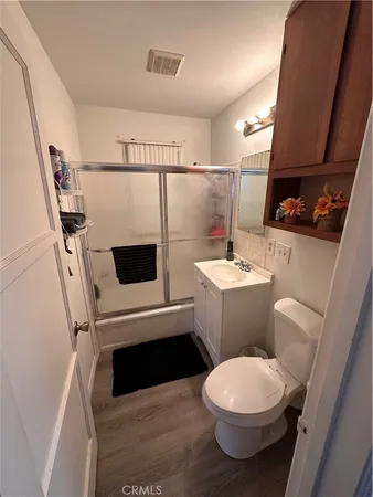 a bedroom with a bed and a night stand