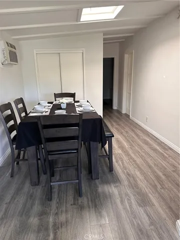 a view of a workspace with furniture and wooden floor