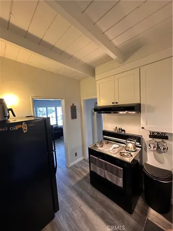 a kitchen with granite countertop a stove and a refrigerator