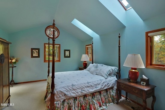 3630 South Massbach Road Stockton, IL 61085 - Photo 12 of 25 a bedroom with a bed and a chandelier next to a window
