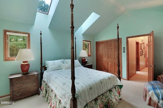 3630 South Massbach Road Stockton, IL 61085 - Photo 13 of 25 a bedroom with a large bed and a chandelier