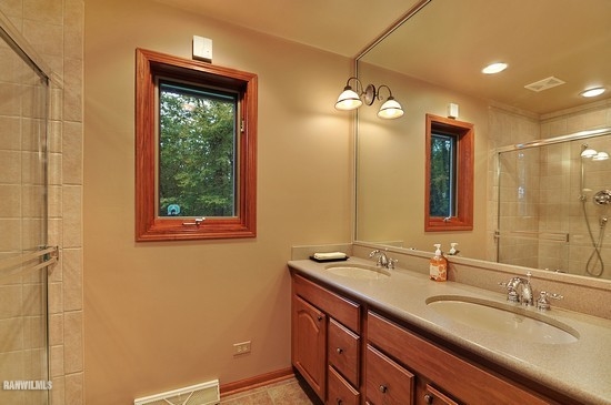 3630 South Massbach Road Stockton, IL 61085 - Photo 9 of 25 a bathroom with a double vanity sink and a mirror