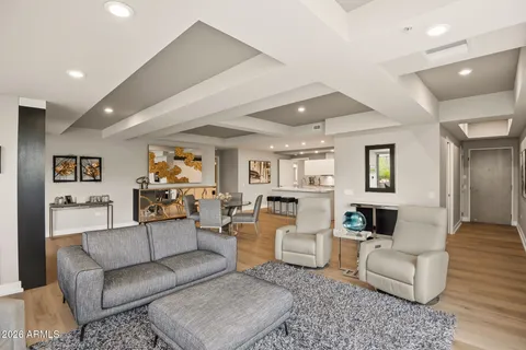 a living room with furniture and floor to ceiling windows