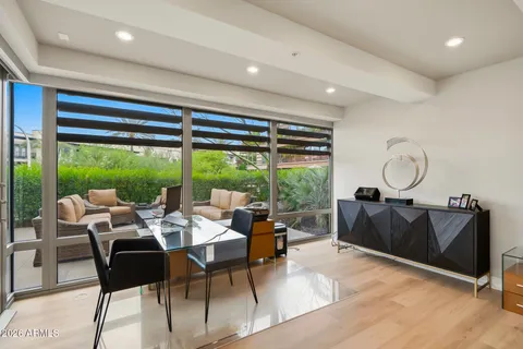 a kitchen with a sink and chairs