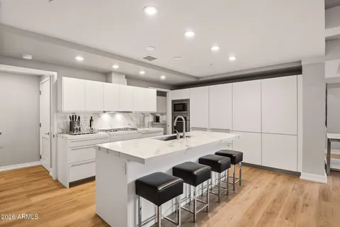 a kitchen with stainless steel appliances kitchen island granite countertop a sink and cabinets