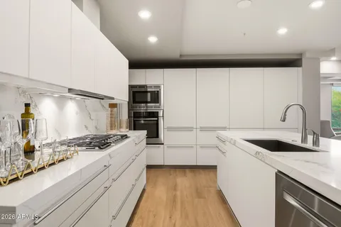 a bedroom with a bed and a view of kitchen