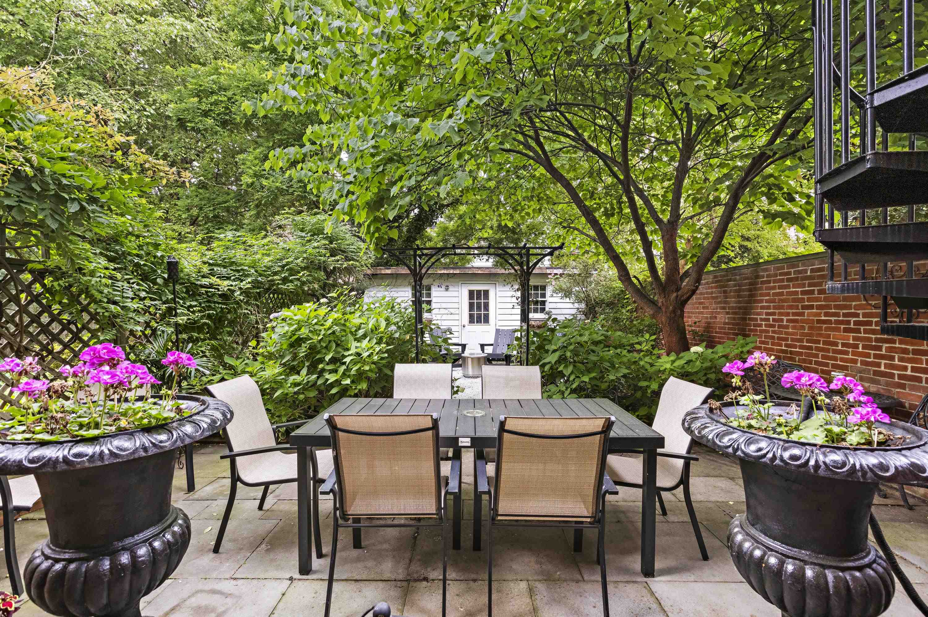a outdoor dining space with furniture and flowers
