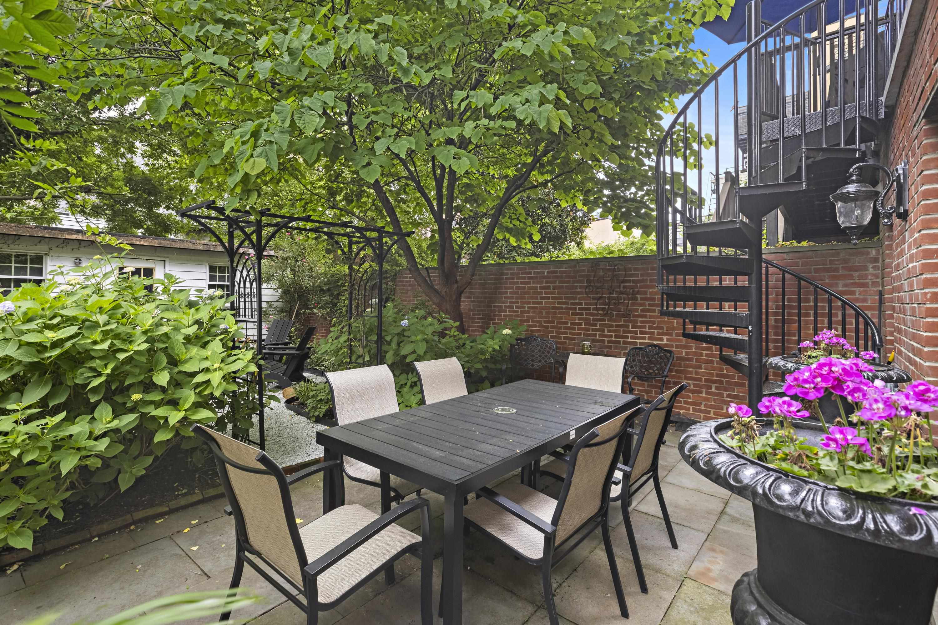 720 Bloomfield Street, Unit 1 Hoboken, NJ 07030 - Photo 11 of 13 a view of a patio with table and chairs potted plants and large tree