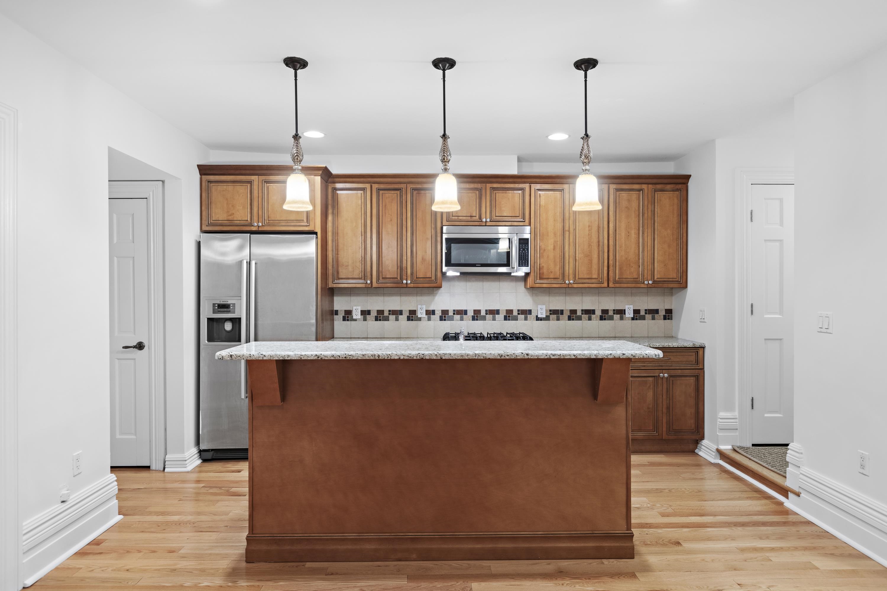 720 Bloomfield Street, Unit 1 Hoboken, NJ 07030 - Photo 5 of 13 a kitchen with stainless steel appliances granite countertop a stove a refrigerator and a sink