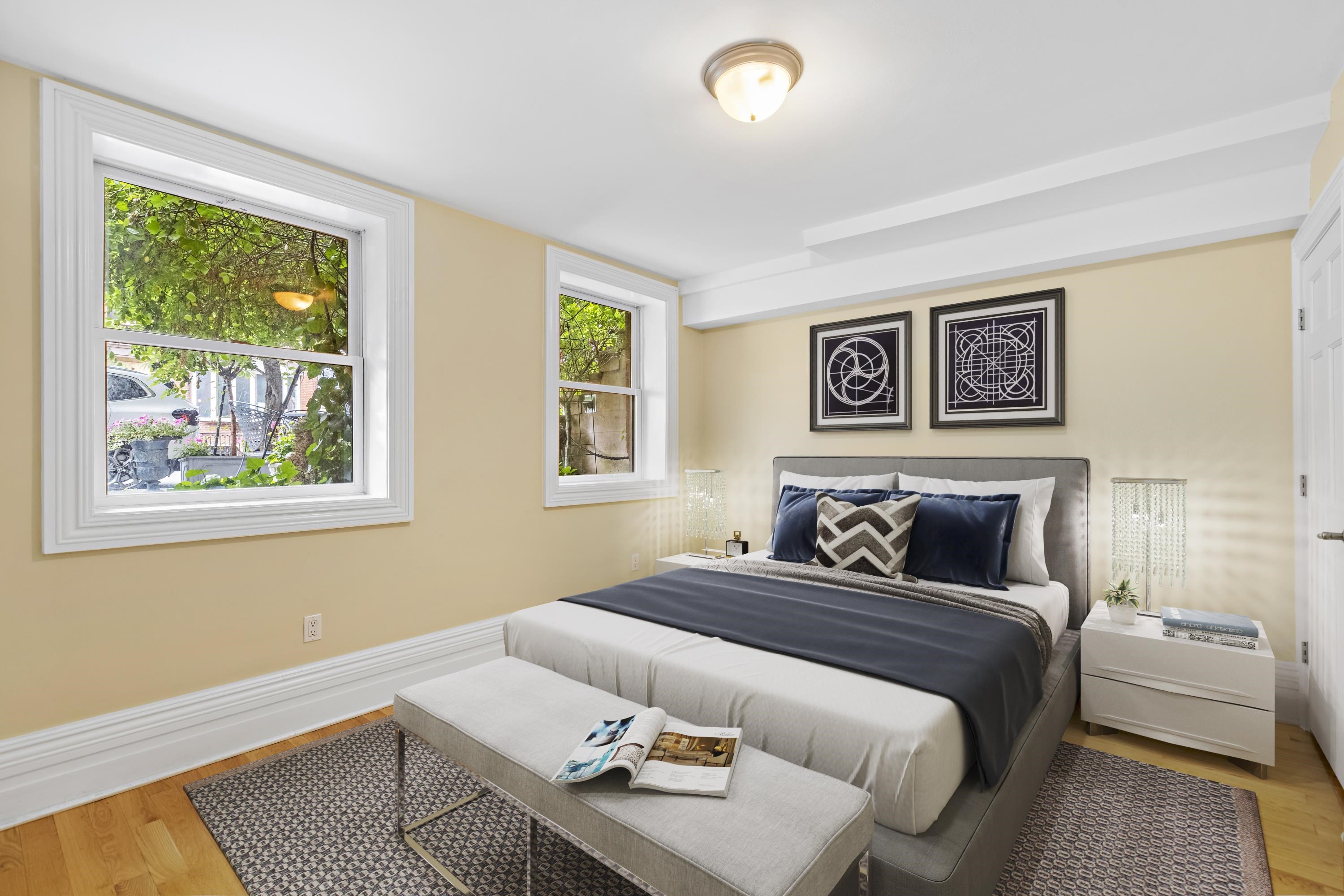 720 Bloomfield Street, Unit 1 Hoboken, NJ 07030 - Photo 7 of 13 a bedroom with a bed and wooden floor