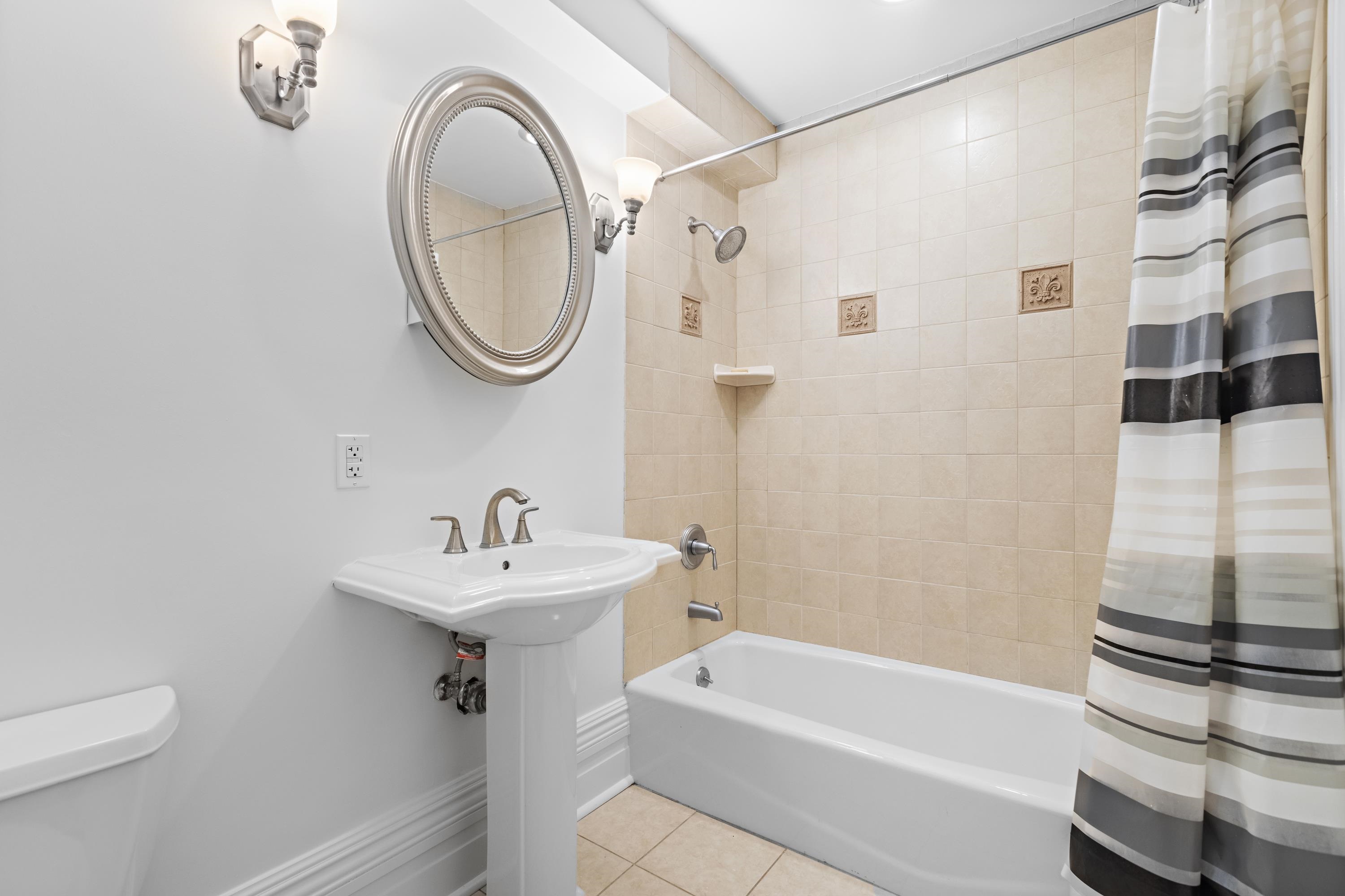 720 Bloomfield Street, Unit 1 Hoboken, NJ 07030 - Photo 9 of 13 a bathroom with a sink a toilet and a mirror