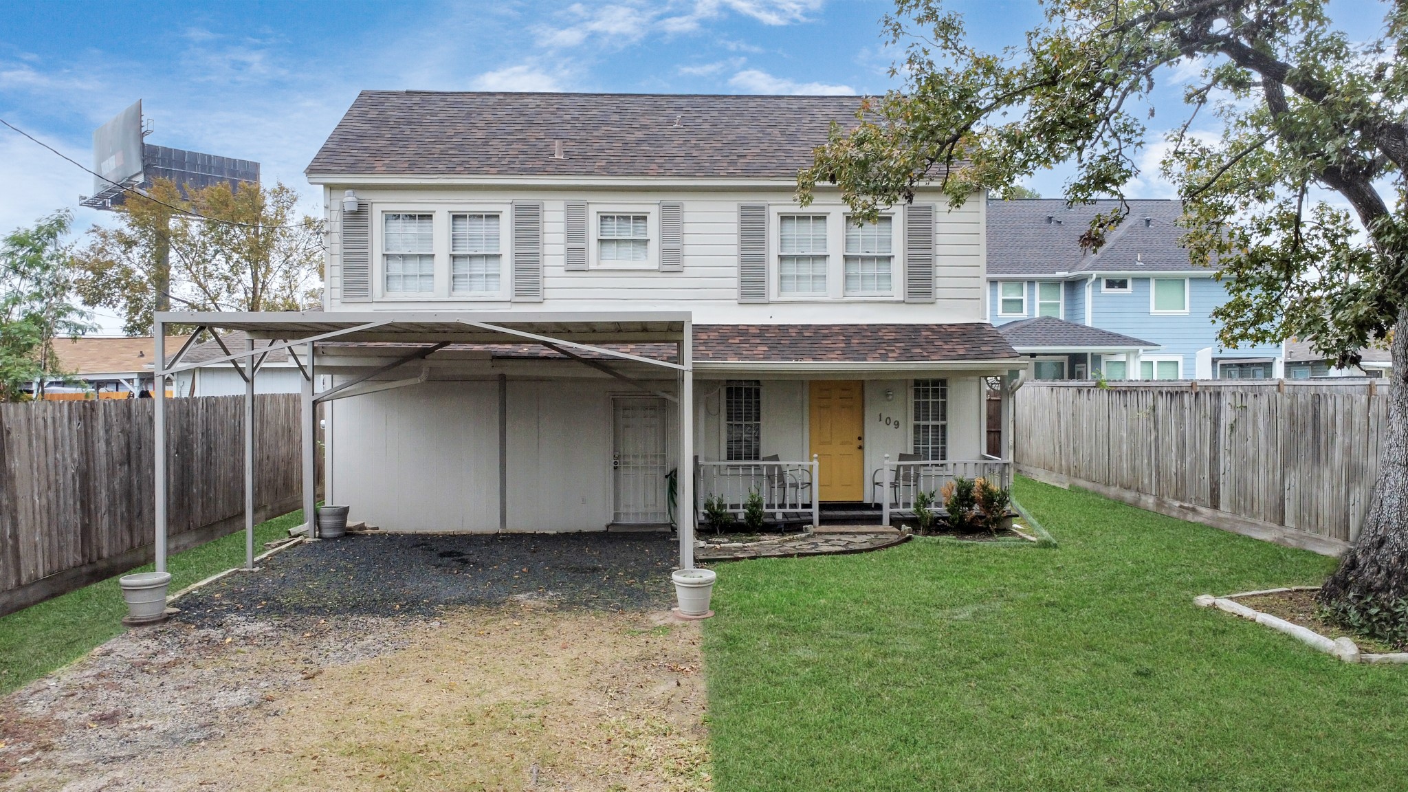 a view of a house with a yard and sitting area