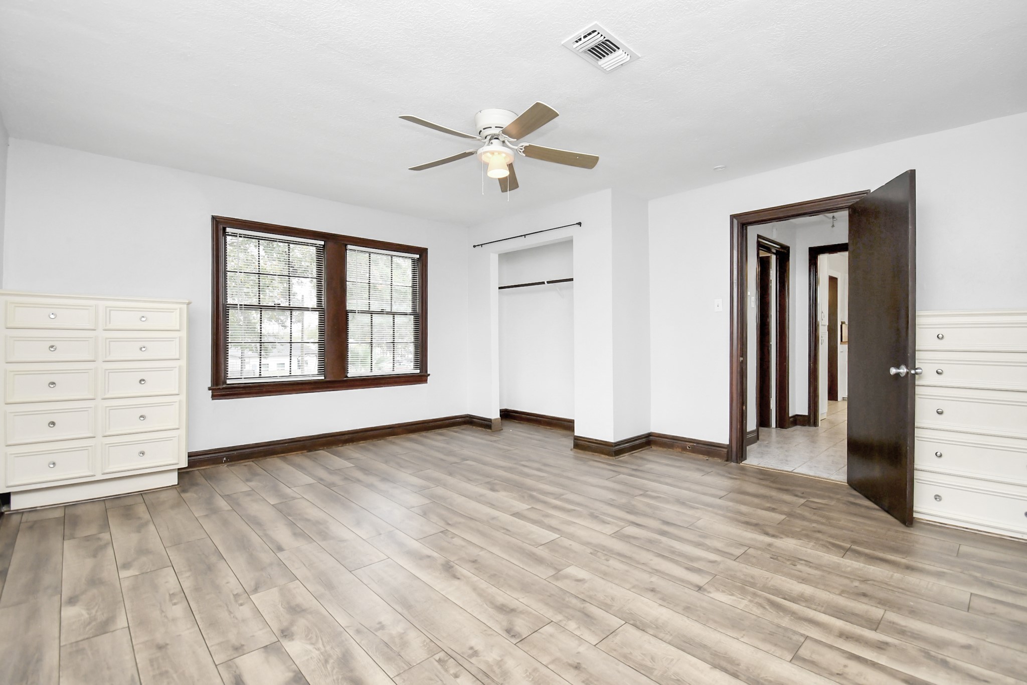 109 Amundsen Street Houston, TX 77009 - Photo 11 of 40 wooden floor in an empty room with a window