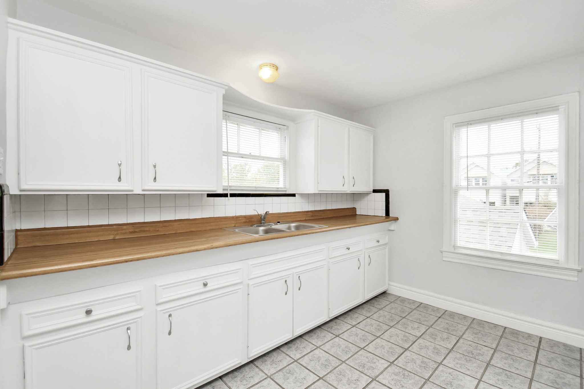 109 Amundsen Street Houston, TX 77009 - Photo 15 of 40 a view of a kitchen with white cabinets