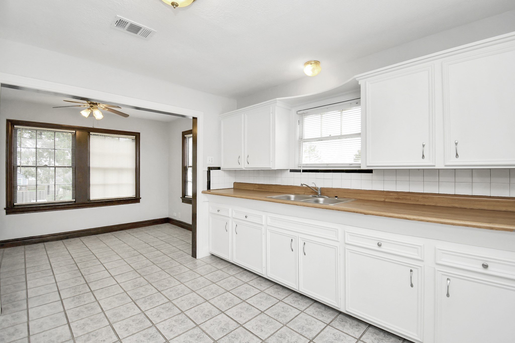 109 Amundsen Street Houston, TX 77009 - Photo 16 of 40 a view of a kitchen with white cabinets and wooden floor