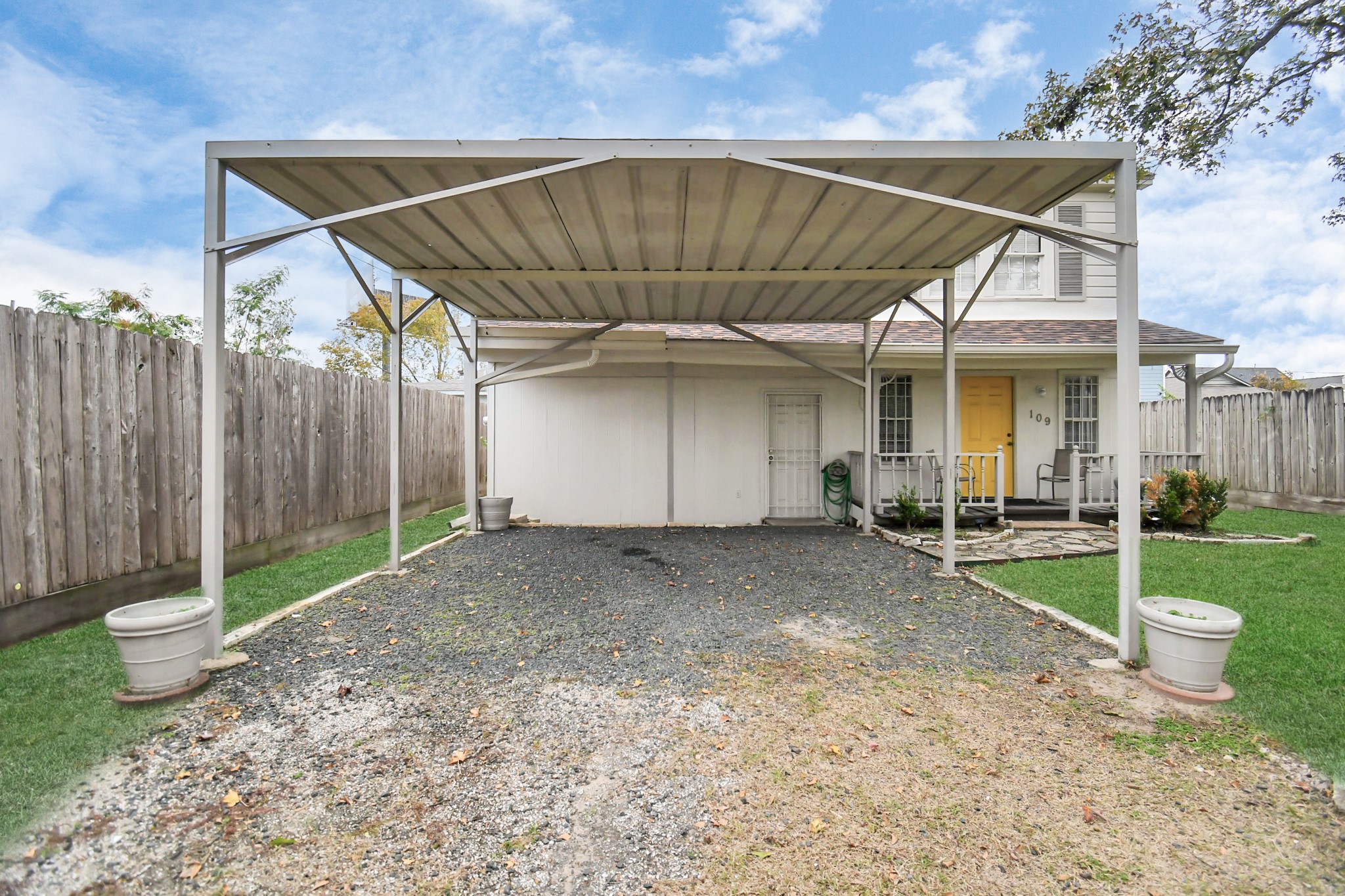 109 Amundsen Street Houston, TX 77009 - Photo 32 of 40 a view of a backyard with table and chairs under an umbrella