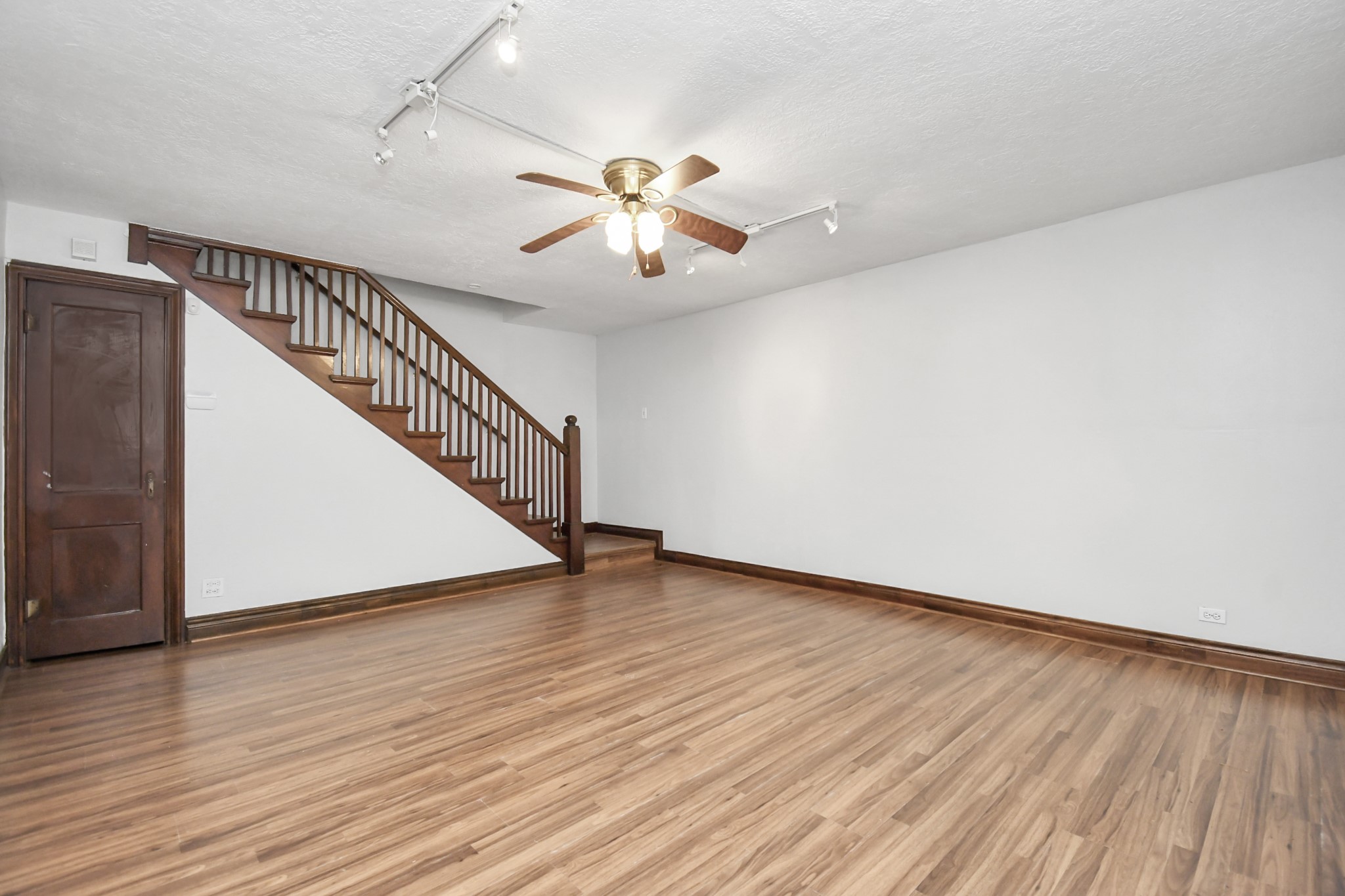 109 Amundsen Street Houston, TX 77009 - Photo 5 of 40 a view of an empty room with wooden floor and a ceiling fan