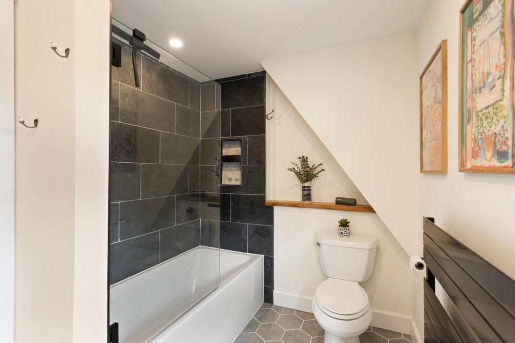 7 Charles Street Maynard, MA 01754 - Photo 15 of 33 a bathroom with a toilet and a bathtub