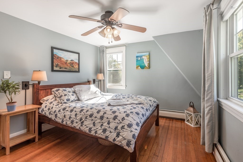 7 Charles Street Maynard, MA 01754 - Photo 19 of 33 a bedroom with a bed and a chandelier