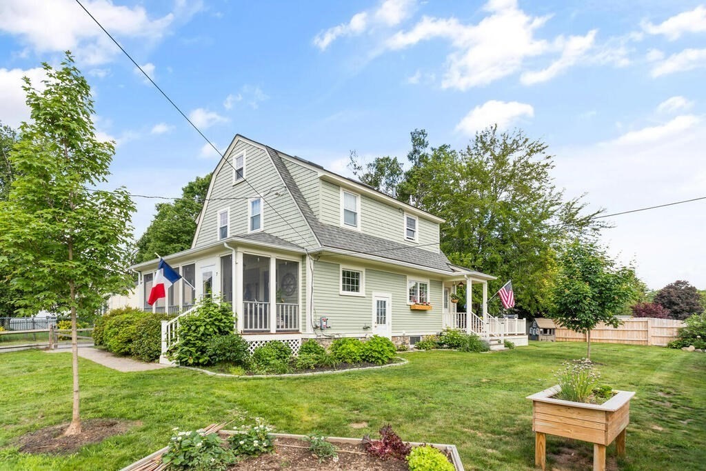 7 Charles Street Maynard, MA 01754 - Photo 2 of 33 a front view of a house with garden