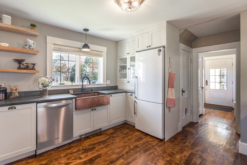 7 Charles Street Maynard, MA 01754 - Photo 4 of 33 a kitchen with stainless steel appliances a refrigerator a sink and white cabinets