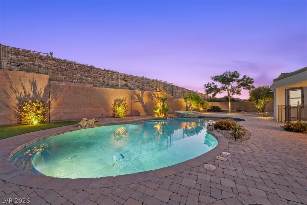 2125 De Rouge Avenue Henderson, NV 89044 - Photo 17 of 96 An inviting pool area with a spa, ideal for twilight relaxation and outdoor gatherings.