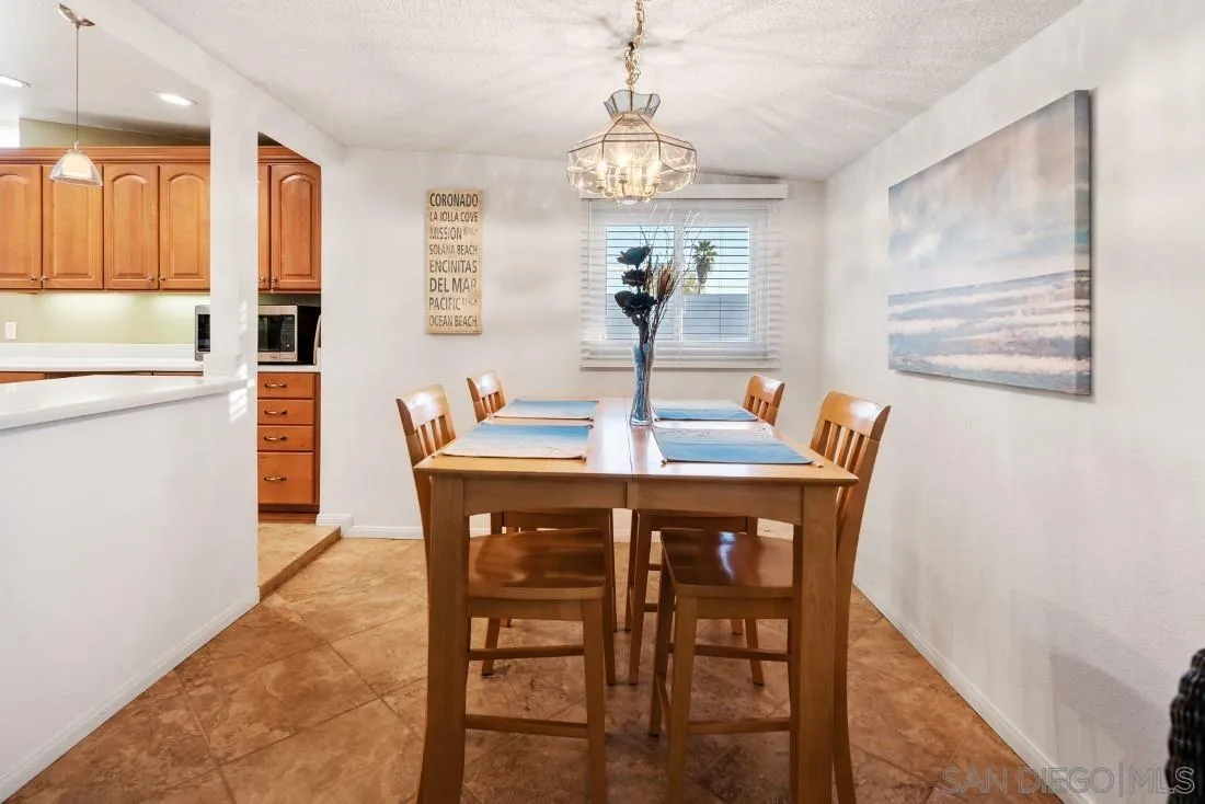 13850 Frame Road Poway, CA 92064 - Photo 13 of 44 a dining room with furniture a chandelier and wooden floor