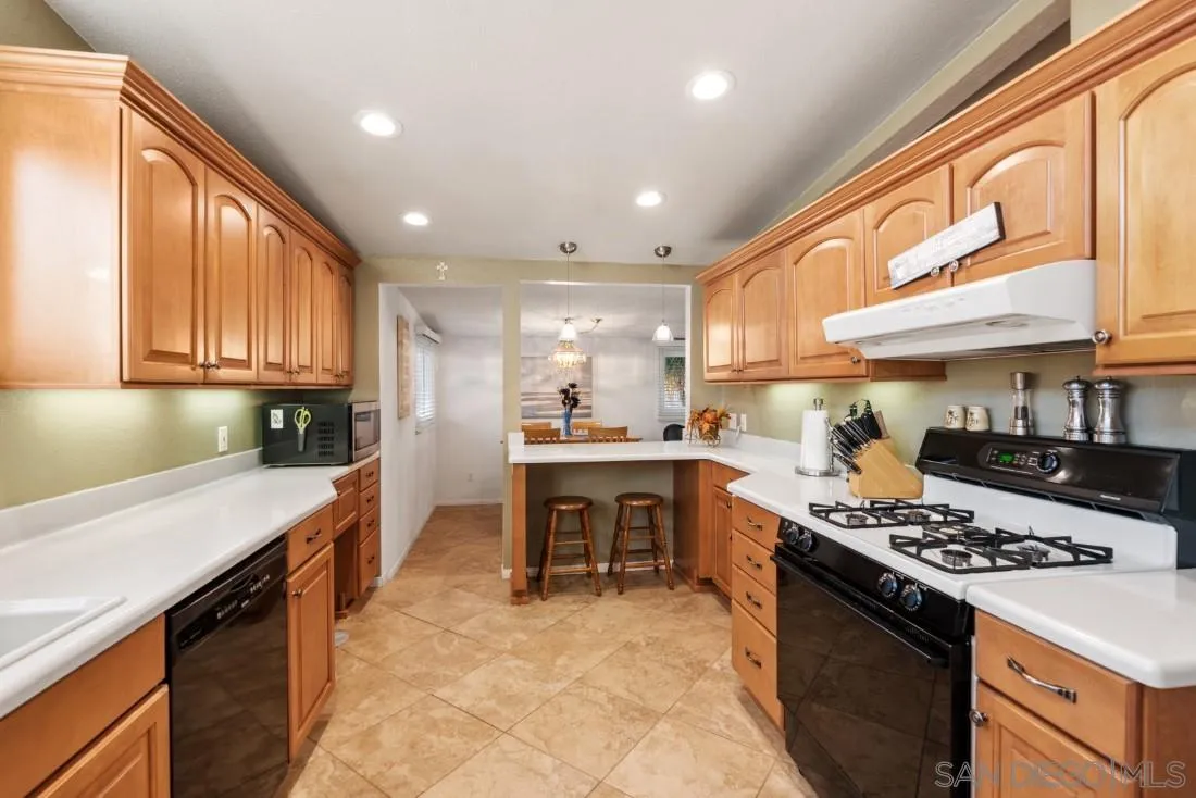 13850 Frame Road Poway, CA 92064 - Photo 17 of 44 a large kitchen with stainless steel appliances granite countertop a stove and a sink